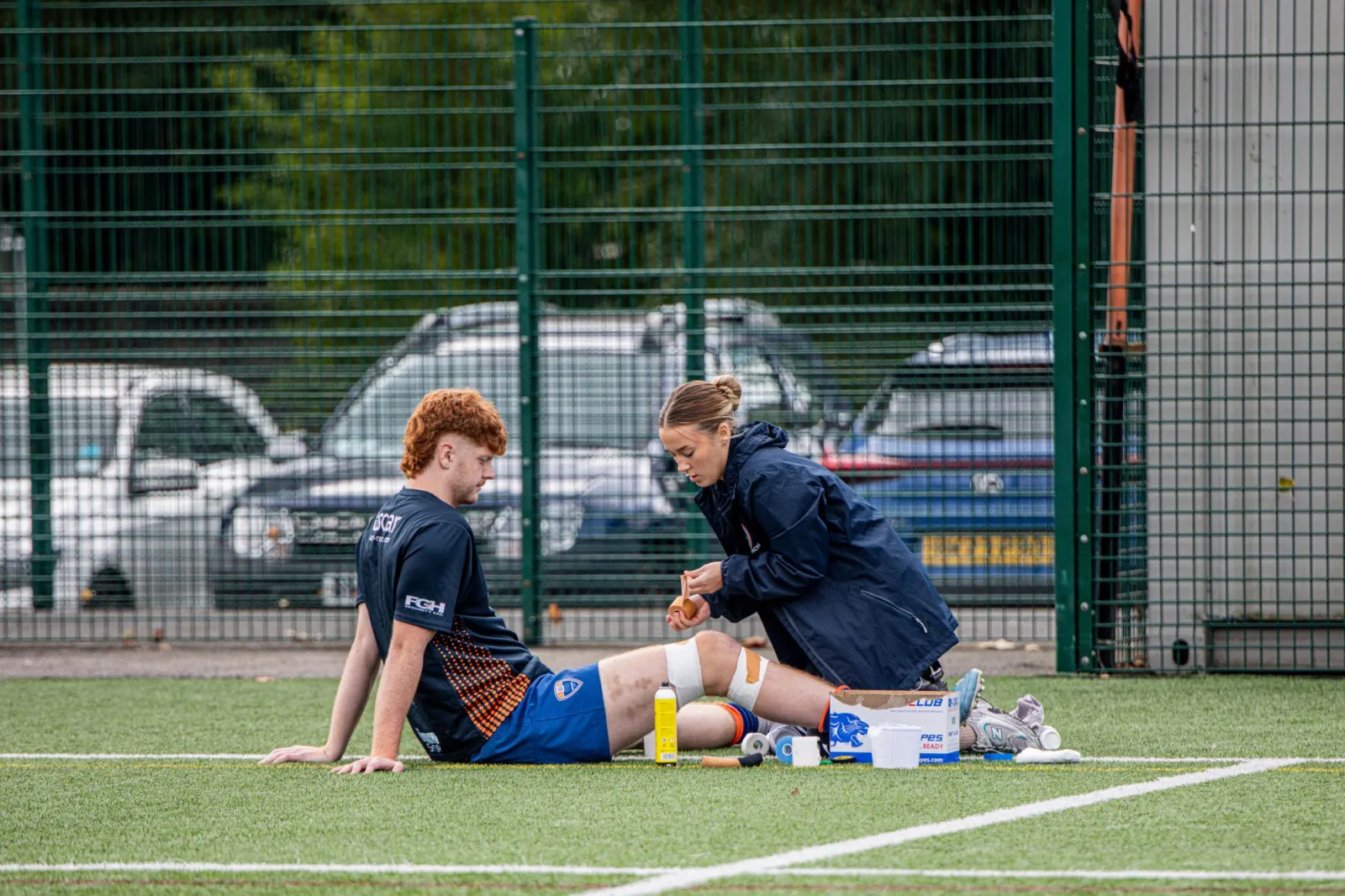 A sports medical team caring for an athlete at the pitch side